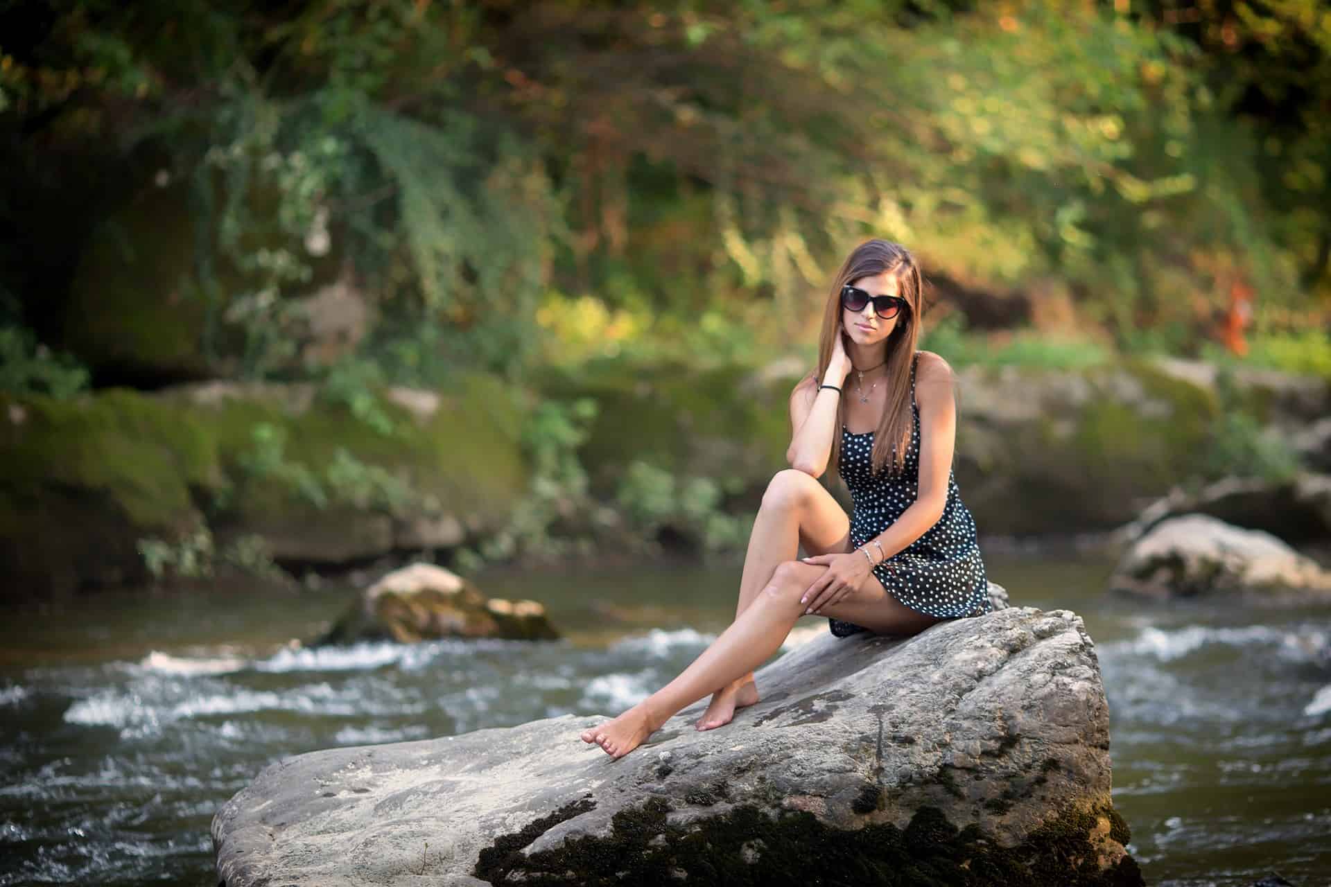 Woman on top of a rock near a body of water