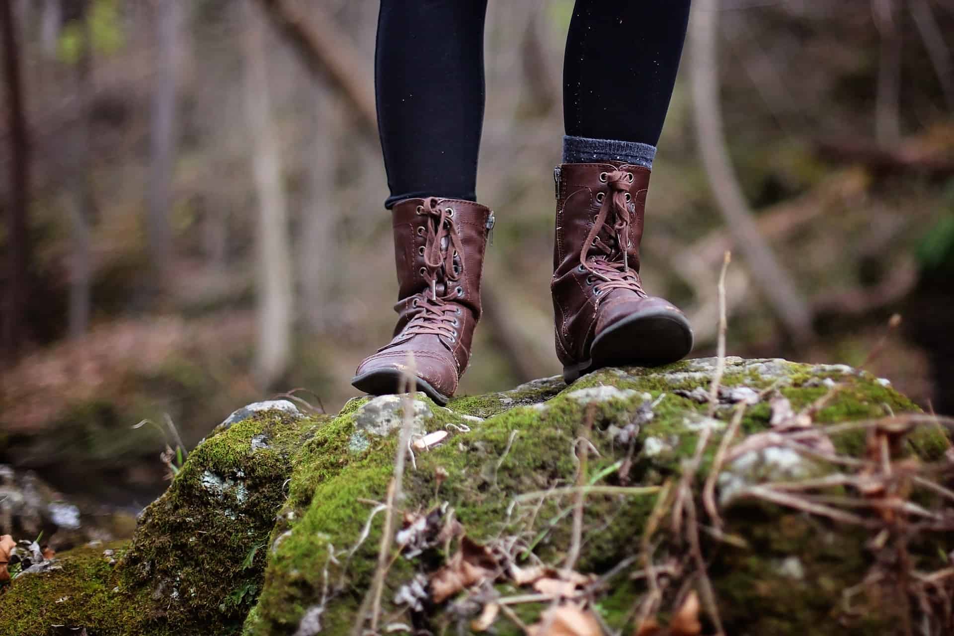 A person is wearing an hiking boots while on the trailhead