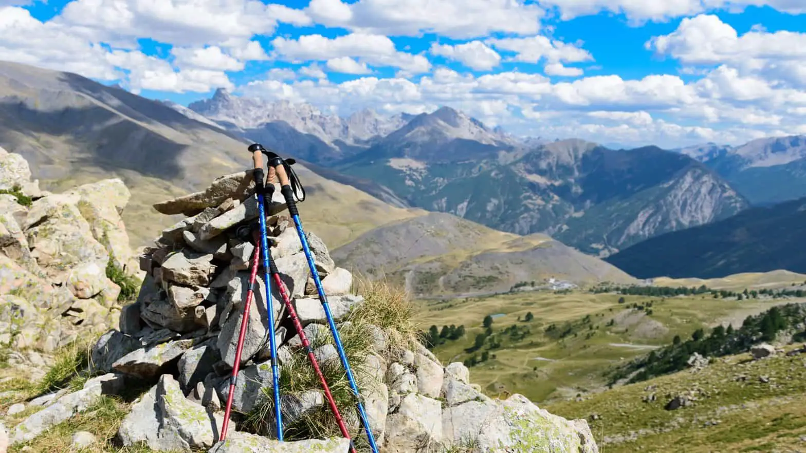 The best hiking poles is placed beside the mountain rocks