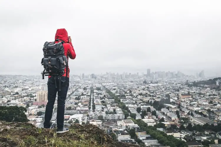 person wearing red hoodie jacket with pack bag