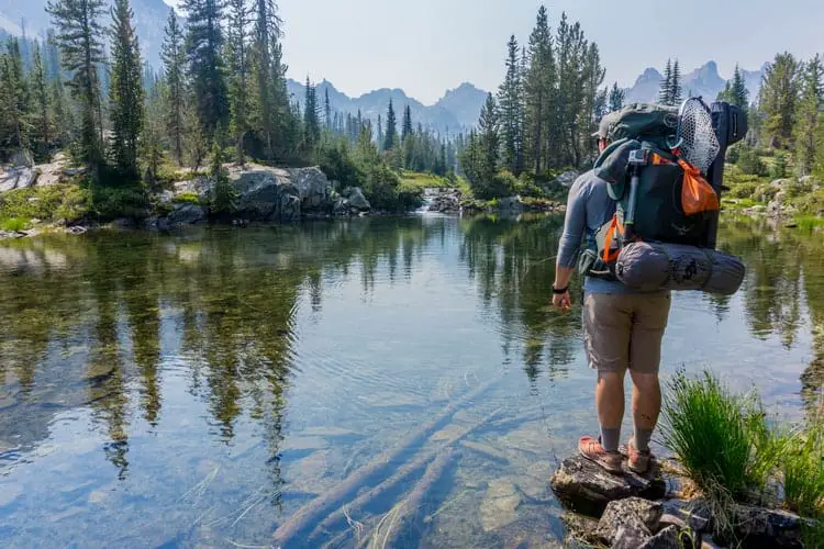 traveler in front of the body of water